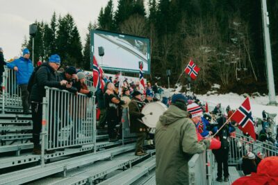 Public avec des drapeaux dans les tribunes d'une épreuve de biathlon